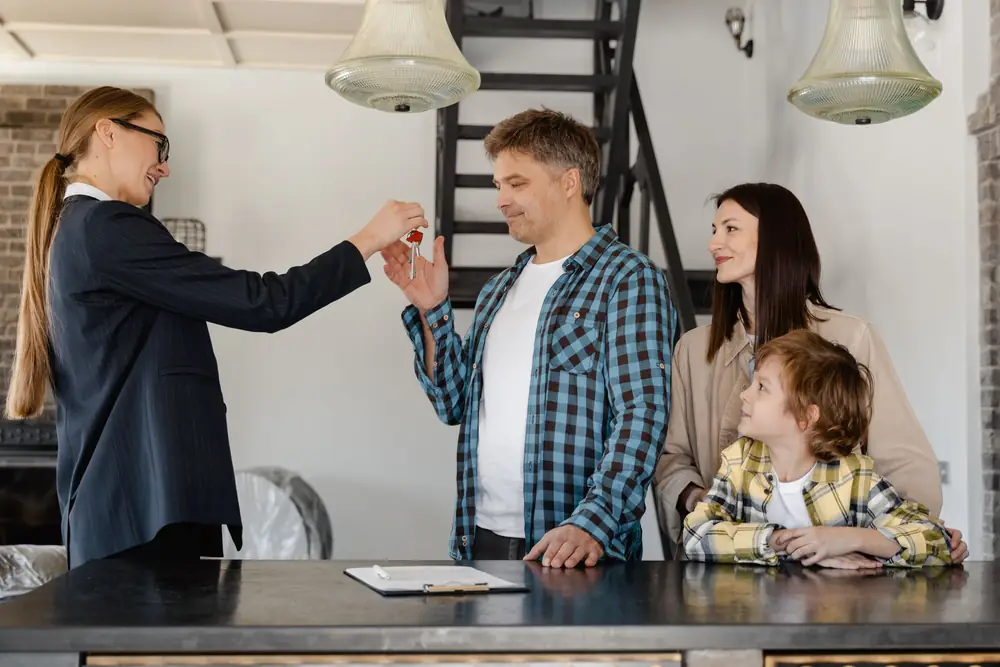 A family receiving the keys to their new home